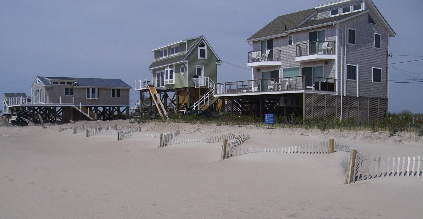 Elevated homes in Westerly, R.I. The green house (center) has been elevated to 5 feet above the base flood elevation.